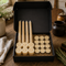 LOONMOON premium beeswax candle gift box with hand-poured Canadian beeswax tapers, votive candles, and tealights arranged in a black kraft gift box in a rustic homestead setting.