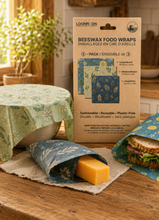 LOONMOON reusable beeswax food wraps made in Canada, shown covering a bowl, wrapping cheese, and holding a sandwich for plastic-free food storage.