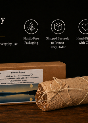 Rustic beeswax taper candles thoughtfully packaged in a kraft box and honeycomb paper wrap tied with twine, set on a wooden surface with messaging highlighting plastic-free packaging, secure shipping, and hand-dipped craftsmanship.