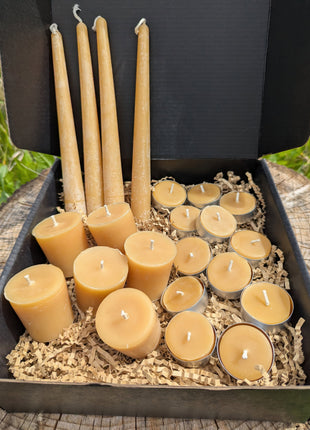 LOONMOON Premium Beeswax Candle Box displayed outdoors in British Columbia with tapers, votives, and tealights in a black gift box.