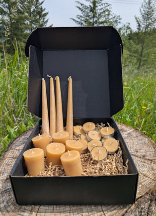 LOONMOON Premium Beeswax Candle Box displayed outdoors in British Columbia with tapers, votives, and tealights in a black gift box.