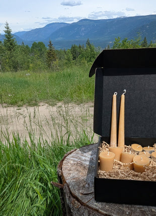 LOONMOON Core Beeswax Candle Box displayed outdoors in British Columbia with beeswax tapers, votives, and tealights.