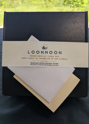 Close-up of LOONMOON Premium Beeswax Candle Box label with blank greeting card and envelope for a Canadian candle gift.
