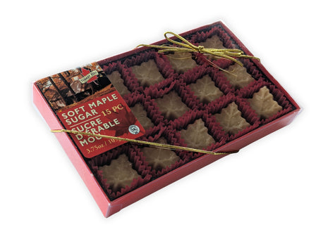 Angled view of the Soft Maple Sugar Candy 15-piece gift box made with pure Canadian maple syrup.  This perspective showcases the elegant gift packaging, clear presentation window, and gold ribbon while emphasizing the premium Canadian maple candy collection.
