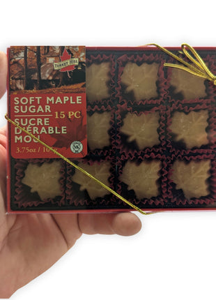 Turkey Hill Soft Maple Sugar Candy 15-piece gift box shown in hand to demonstrate the actual size of the product.  This image helps customers visualize the dimensions of the premium Canadian maple candy gift box before purchasing.