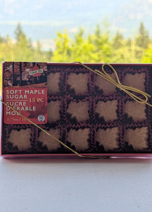 Soft Maple Sugar Candy 15-piece gift box photographed against a scenic Canadian mountain landscape.  The natural outdoor setting reflects the Canadian heritage of these premium maple candies made with pure Canadian maple syrup.