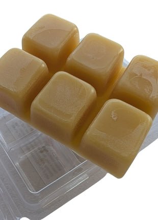 Close-up of six natural golden beeswax melt cubes displayed in an open clear clamshell on a white background.  This product image emphasizes the smooth wax texture, cube shape, and simple clean presentation of the LOONMOON beeswax melts.