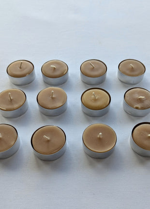 Twelve beeswax tealight candles are displayed in three neat rows from a slightly angled front view on a white background.  This perspective shows the natural wax tops, cotton wicks, compact candle height, and individual aluminum tealight cups more clearly than an overhead image alone.