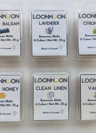 Six LOONMOON beeswax melt clamshells arranged on a clean white background, showing the full scent collection in Cedar Balsam, Lavender, Citronella, Soft Honey, Clean Linen, and Vanilla.  This product image highlights the complete six-scent beeswax wax melt bundle in 55 g clamshell packages, ideal for shoppers comparing the full collection.