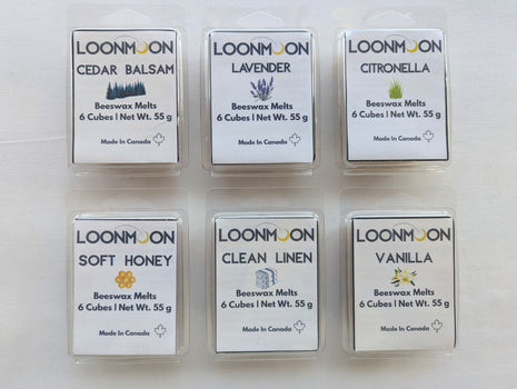 Six LOONMOON beeswax melt clamshells arranged on a clean white background, showing the full scent collection in Cedar Balsam, Lavender, Citronella, Soft Honey, Clean Linen, and Vanilla.  This product image highlights the complete six-scent beeswax wax melt bundle in 55 g clamshell packages, ideal for shoppers comparing the full collection.
