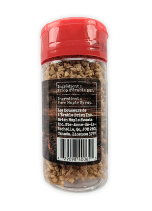 This image shows the back of the Brien Authentique maple sugar shaker on a white background.  The clear shaker contains coarse maple sugar and has a red lid, with the back label displaying ingredient information, manufacturer details, and barcode.  The ingredient is listed as pure maple syrup, and the product is associated with Brien Maple Sweets in Quebec, Canada.  This image helps customers view the back packaging details and product information.