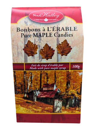 Front view of a 100 g package of Canadian hard maple candies made with pure maple syrup, featuring maple-leaf-shaped candies on the bilingual packaging. Made in Canada, these traditional maple sweets offer a distinctly Canadian maple candy experience.