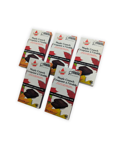 Five Maple Crunch dark chocolate bars arranged in an angled display.  Angled group display of five Canadian Maple Crunch Dark Chocolate Bars showing the consistent retail packaging from multiple viewing angles.