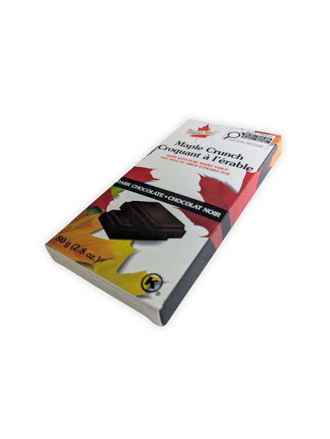 Angled view of the Canadian Maple Crunch dark chocolate bar package made with pure maple syrup.  Angled perspective of the Canadian Maple Crunch Dark Chocolate Bar highlighting the retail packaging and premium presentation of this Canadian maple chocolate treat.