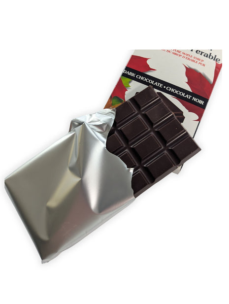 Unwrapped Canadian Maple Crunch dark chocolate bar partially removed from its silver wrapper.  Canadian Maple Crunch Dark Chocolate Bar partially unwrapped to reveal the rich dark chocolate inside, allowing customers to see the actual product before purchase.
