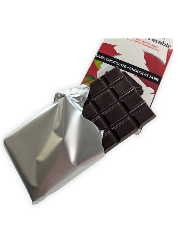 Unwrapped Canadian Maple Crunch dark chocolate bar partially removed from its silver wrapper.  Canadian Maple Crunch Dark Chocolate Bar partially unwrapped to reveal the rich dark chocolate inside, allowing customers to see the actual product before purchase.