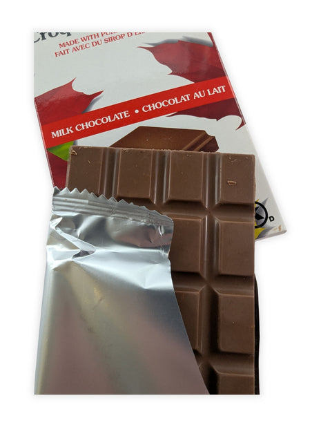 Canadian Maple Crunch milk chocolate bar partially unwrapped to reveal smooth milk chocolate made with pure Canadian maple syrup.  Opening the wrapper showcases the rich milk chocolate and gives customers a closer look at the premium confection inside.