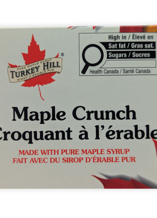 Close-up of the Canadian Maple Crunch milk chocolate package showing the product name, maple syrup branding, and bilingual packaging.  This detailed view highlights the product branding and quality packaging that customers see before opening the chocolate.