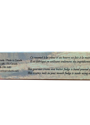 Package panel from Canadian maple fudge showing the Made in Canada maple-leaf symbol and information describing the product as cream and butter fudge made in small batches. The 60 g maple fudge is made in Canada and marketed as a creamy maple confection made with pure maple syrup.
