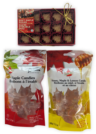 Canadian maple treat sampler featuring a 15-piece box of soft maple sugar candies, traditional maple candies, and honey, maple and lemon candies arranged together on a clean white background.  This complete product view clearly shows the three Canadian-made maple treats included in the sampler and their colourful retail packaging.