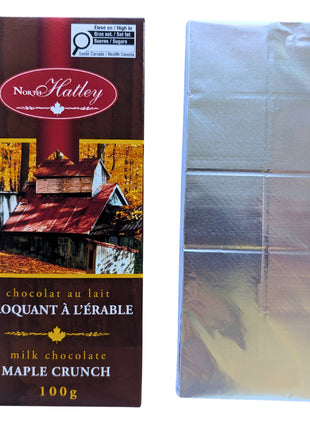 Canadian Milk Chocolate Maple Crunch package displayed beside the silver-wrapped chocolate bar inside. The 100 g bar combines milk chocolate and maple sugar in a Canadian maple treat.