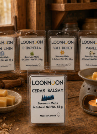 LOONMOON Cedar Balsam beeswax wax melts shown with Clean Linen, Citronella, Soft Honey, and Vanilla scents in a rustic workshop setting with wax cubes and a warmer.