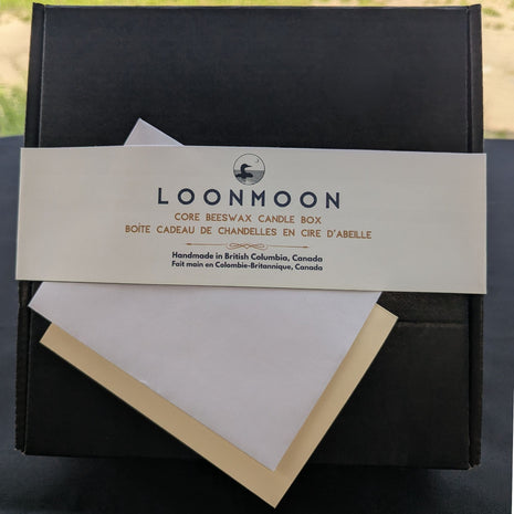 Close-up of LOONMOON Core Beeswax Candle Box label with blank greeting card and envelope for a Canadian candle gift.