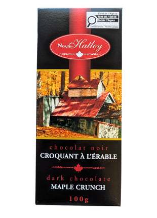 Front view of a 100 g  Dark Chocolate Maple Crunch bar in its black and red Canadian maple-themed package. This Canadian dark chocolate treat combines dark chocolate with maple sugar for a distinctly Canadian maple chocolate experience.