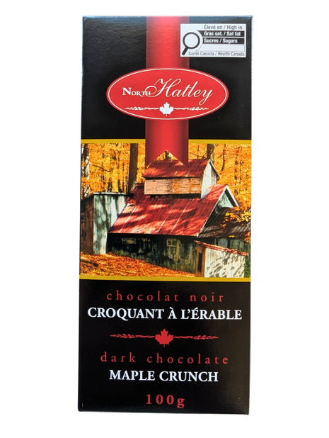 Front view of a 100 g  Dark Chocolate Maple Crunch bar in its black and red Canadian maple-themed package. This Canadian dark chocolate treat combines dark chocolate with maple sugar for a distinctly Canadian maple chocolate experience.