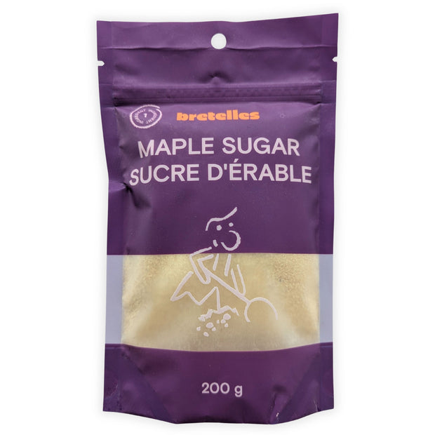 A front view of a 200 g resealable pouch of fine maple sugar photographed on a clean white background.  The purple bilingual package displays Maple Sugar and Sucre d’érable, a one-ingredient symbol and a transparent window showing the light golden maple sugar inside.