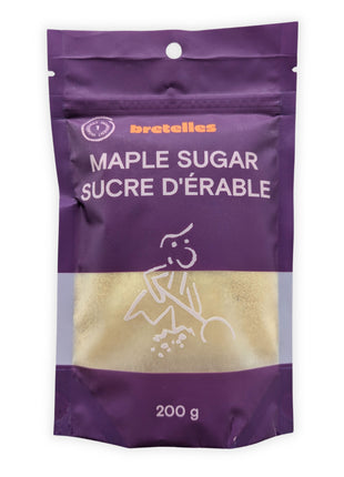 A front view of a 200 g resealable pouch of fine maple sugar photographed on a clean white background.  The purple bilingual package displays Maple Sugar and Sucre d’érable, a one-ingredient symbol and a transparent window showing the light golden maple sugar inside.