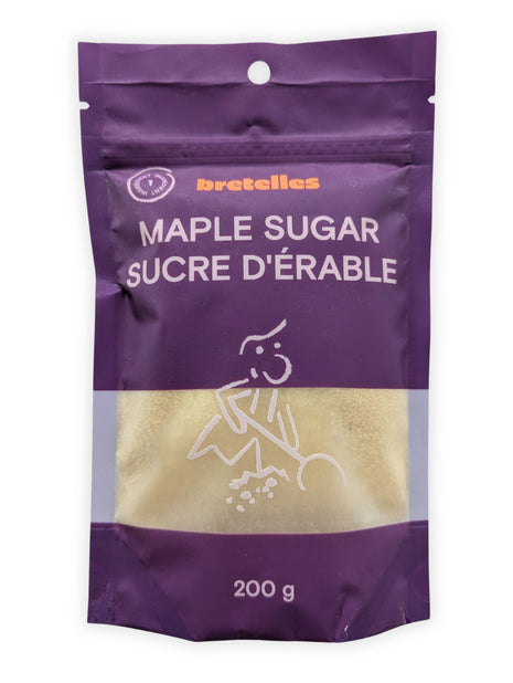 A front view of a 200 g resealable pouch of fine maple sugar photographed on a clean white background.  The purple bilingual package displays Maple Sugar and Sucre d’érable, a one-ingredient symbol and a transparent window showing the light golden maple sugar inside.
