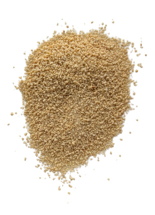 A detailed close-up of loose fine maple sugar on a clean white background, showing its natural light golden colour, small irregular granules and dry crystalline texture for an accurate view of the product outside the package.