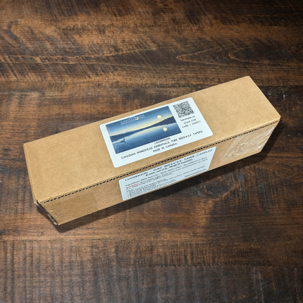 LOONMOON beeswax taper candles gift box on a rustic wooden table, with branded moonlit lake label and QR code for care and safety instructions.