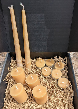 Open LOONMOON beeswax candle gift box with pure beeswax tapers, votives, and tealights packed in kraft crinkle paper.
