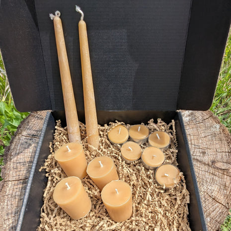 Open LOONMOON beeswax candle gift box with pure beeswax tapers, votives, and tealights packed in kraft crinkle paper.