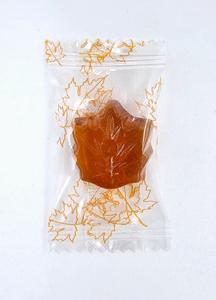 Individually wrapped Canadian maple leaf candy made with pure maple syrup on a white background
