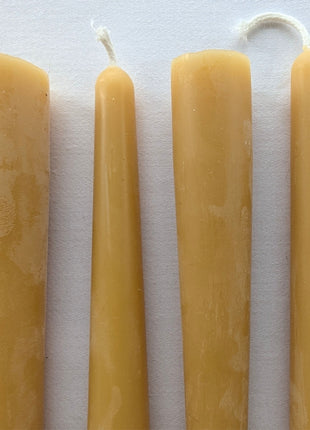 Close-up comparison of natural beeswax taper candles included with the LOONMOON Premium Candle Gift Box, showing their warm golden colour, smooth hand-finished surfaces, and natural cotton wicks against a clean white background.  The image highlights the authentic variation and handcrafted character of Canadian beeswax candles.