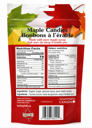 The back of the 90 g maple hard candy package photographed clearly on a white background, showing the bilingual Nutrition Facts panels, serving size, calorie and sugar information, ingredient list, barcode, distributor information, and processed-in-Canada statement.  The ingredients identify sugar, glucose syrup, and pure maple syrup.