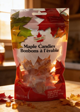 Maple candies in a bag, made with pure Canadian maple syrup, displayed on a rustic table with warm sunlight and autumn leaves