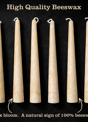 Six off-white beeswax taper candles on a black background with text ‘High Quality Beeswax’ and a caption pointing out wax bloom as a natural sign of 100% beeswax.