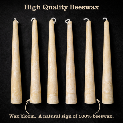 Six off-white beeswax taper candles on a black background with text ‘High Quality Beeswax’ and a caption pointing out wax bloom as a natural sign of 100% beeswax.