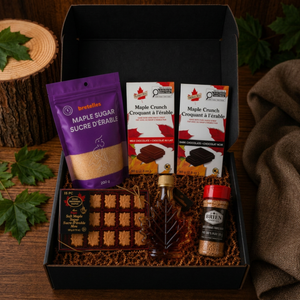 Premium Canadian maple gift box with maple syrup, maple sugar candies, maple sugar shaker, and Belgian maple chocolate bars in a black presentation box.