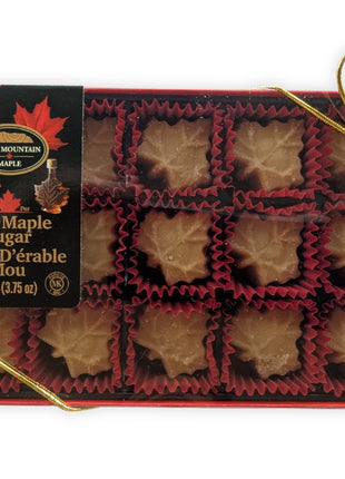 Premium front view of a 15-piece soft maple sugar candy gift box made in Canada, featuring individually wrapped maple leaf candies in a red gift box with elegant gold ribbon.  Pure Canadian maple sugar candy gift for holidays, birthdays, corporate gifts, souvenirs and authentic Canadian food lovers.