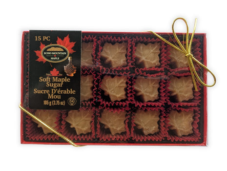 Premium front view of a 15-piece soft maple sugar candy gift box made in Canada, featuring individually wrapped maple leaf candies in a red gift box with elegant gold ribbon.  Pure Canadian maple sugar candy gift for holidays, birthdays, corporate gifts, souvenirs and authentic Canadian food lovers.