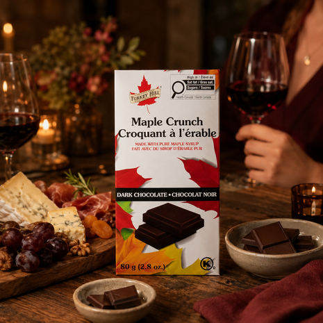 Maple Crunch dark chocolate bar styled for a dinner date with red wine, charcuterie, soft cheeses, fruit, nuts, and chocolate pieces.